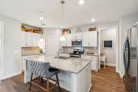 This bright kitchen has an eat on island, lots of cabinet space and a corner pantry