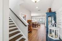 This home showcases an open concept living with hardwood floors & stairs.