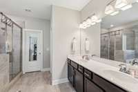 Beautifully appointed shower with double vanities and a large walk in closet