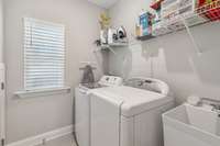 Utility room has a laundry tub and extra storage