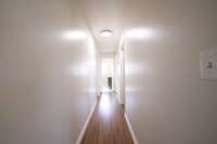 Well lit hallway off the foyer.