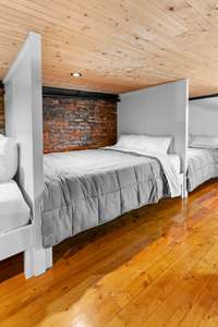 Bunk space is home to 4 full-size beds with dividing walls for extra privacy.