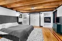 The Master bedroom has built-in bookshelves, a gas fireplace, and a secondary entrance to the hallway.