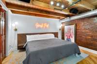 Bedroom 2 brings the vibe with a neon sign: Nash Pad!