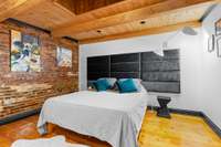 Bedroom 3 upstairs has a skylight to keep things bright while the exposed brick sets the vibe