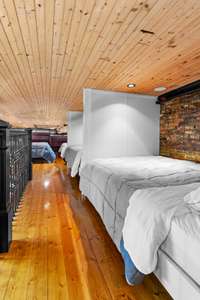 Bunk space is home to 4 full-size beds with dividing walls for extra privacy.