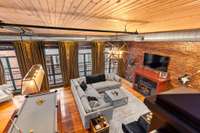 View of the living room from the stairs to the rooftop terrace! The living room also provides access to your private balcony overlooking Printer's Alley.