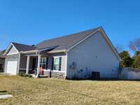 House has Attractive Gray Siding and Gray and Black Decorative Stacked Stone.