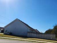 House has a Privacy Fenced Backyard and Retractable Awning over the Patio.