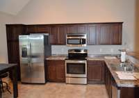 Kitchen Features Stainless Smooth Top Stove, Refrigerator, Microwave and Dishwasher.