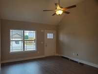 Spacious Living Room with Vaulted Ceiling. House is Occupied currently. This is a picture of the Living Room when the House was built.