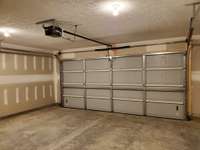 Two Car Garage with Garage Door Opener.  Drywall in Garage is Finished and Ready to be Painted.
