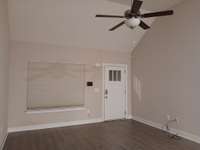 Vaulted Ceiling and Plank Flooring in the Living Room.