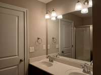 Primary Bath has Custom Cabinets and 2 Sinks.