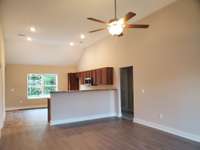 Living Room is separated from the Kitchen by a Raised Bar Countertop.  Picture of Similar House.