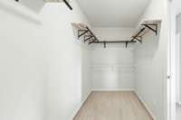 Spacious primary walk in closet, separate from the bedroom.