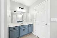Primary bathroom with separate vanities.