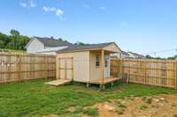 The storage building is 12 x 16 and has a double door on the side, a mini porch with a door and window in the front.  Inside storage area is 12 x 12!
