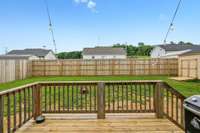 Here's the rear deck and a good look at the 8 ft fence the sellers had installed.  The lawn is in the process of being established.