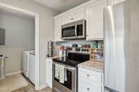 All stainless steel appliances in the Kitchen remain with the home (Frigidaire electric stove, microwave, dishwasher & Samsung REFRIGERATOR)!