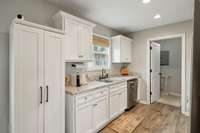 Kitchen has great white cabinetry and nice countertops! Also, close access to the Laundry!