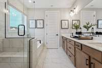Choose between a shower and tub or shower and linen closet at NO COST in your primary suite! Ceramic tile floors & shower walls, quartz countertops, and raised height double vanities are included.