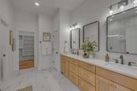 Double vanities, large, tiled shower, linen closet, and water closet