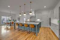 Quartz countertops, pendant lights, and stainless steel appliances are just a few of the features of this kitchen.