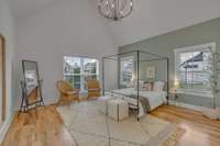 Primary has vaulted ceilings and looks out on the quiet backyard