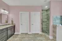 Master bedroom with double vanity and custom stand up shower.