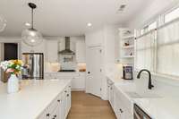Generous countertop space and cabinetry provide ample prep and storage.