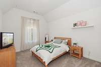 One of the secondary bedrooms upstairs perfect for family or guests.