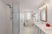 A spa-inspired primary bath with separate soaking tub and walk-in tile shower