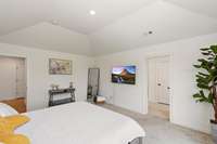 Another view of the primary bedroom with plush carpet and trey ceiling creating a spacious and airy atmosphere.
