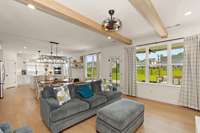 Natural light pours in through the large windows, creating a bright and airy feel.