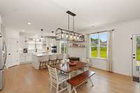 Modern light fixtures like the one in the dining area provide both ambiance and functionality.