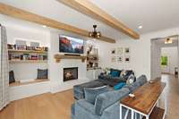 a cozy gas fireplace anchors the pace flanked by custom built-ins that provide the perfect combination of style and storage.