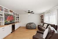 The built-ins and cabinetry for storage, wet bar and drink refrigerator make this the perfect media room.