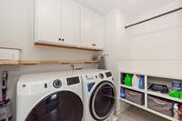 The laundry has been thoughtfully designed with easy-care surfaces, tile flooring, and cabinetry making laundry more pleasant and manageable.