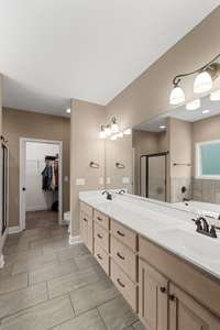Vanity with two sinks in the primary bathroom.