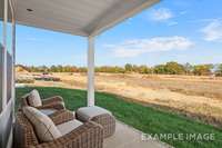 The included covered back patio offers a relaxing space to entertain, or simply unwind. Photo is of a model. Not the subject property.
