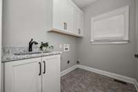Check out the flooring in this utility room that offers the convenience of a sink and extra storage!