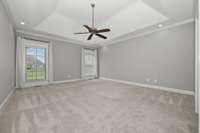 First floor primary bedroom with tray ceiling.