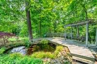 STUNNING KOI POND, AND PLANTINGS, OBSERVATION DECK TO ENJOY THIS GARDEN