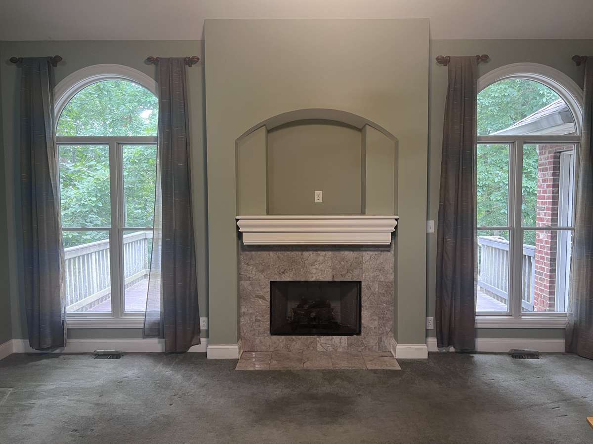 Living room space with fireplace and soaring ceilings
