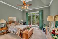 PRIMARY BEDROOM MAIN LEVEL OF HOME WITH TREY CEILING.