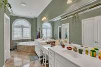 PRIMARY BATHROOM HAS HIGHER CABINETS, NO BENDING, DOUBLE SINKS AND MAKE UP SPACE, SOAKING TUB AND SEPARATE SHOWER.  BEAUTIFUL MARBLE FLOORS.