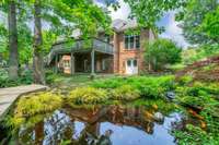 ANOTHER VIEW OF KOI POND AND BACK OF HOUSE.