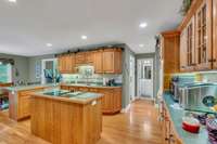 WORKING KITCHEN WITH ISLAND AND BEAUTIFUL CABINETS, THIS EAT IN KITCHEN HAS PLENTY OF SPACE FOR STORAGE, EASY ACCESS TO BACK DECK AREA, AND GARAGE SPACE IS STEPS AWAY SO YOU DON'T HAVE MANY STEPS TO UNLOAD THE CAR.