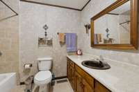 The full guest bathroom features custom tile work and an extended single vanity for extra counter space. 4835 Summertown Hwy Summertown, TN 38483